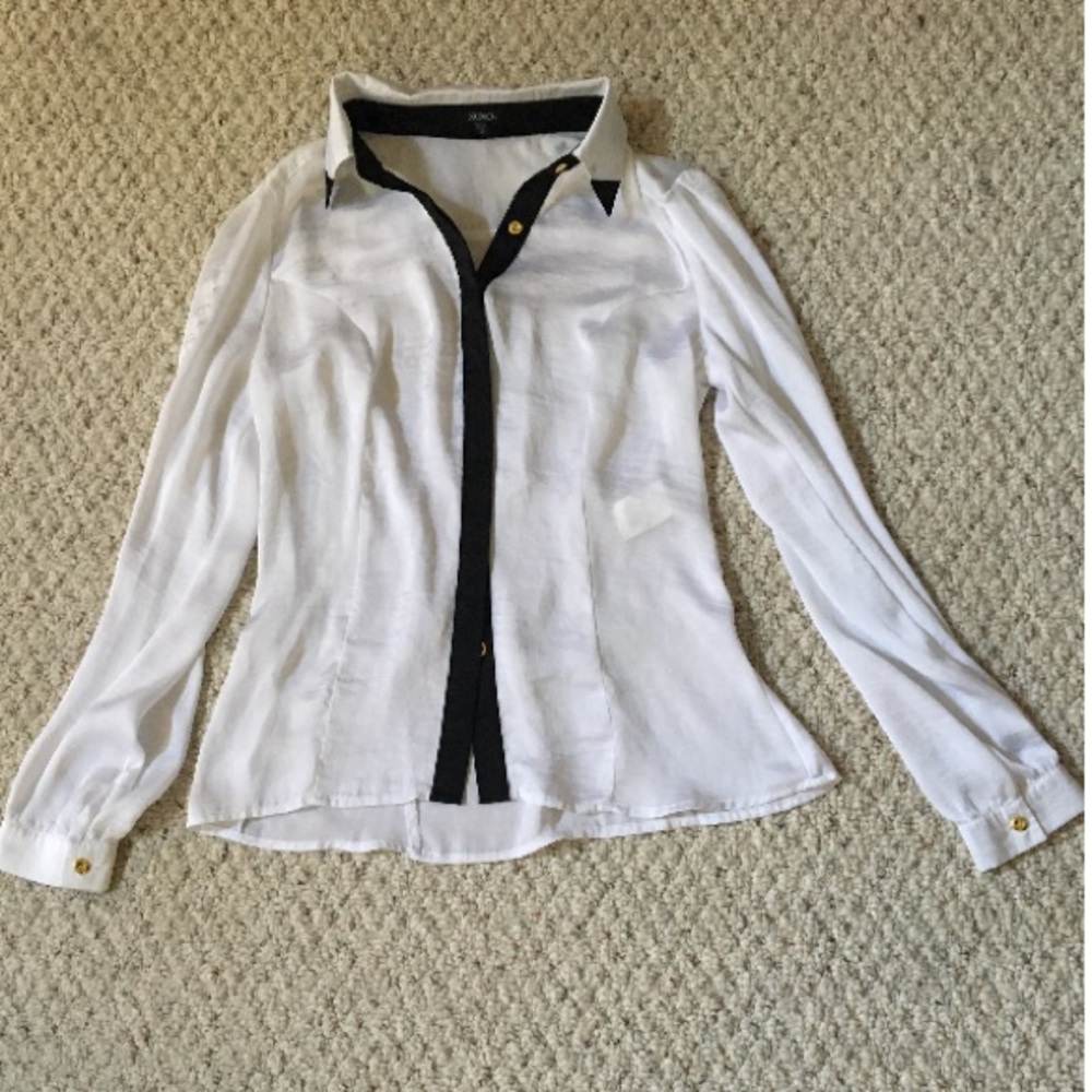 White silky button up blouse with black lining